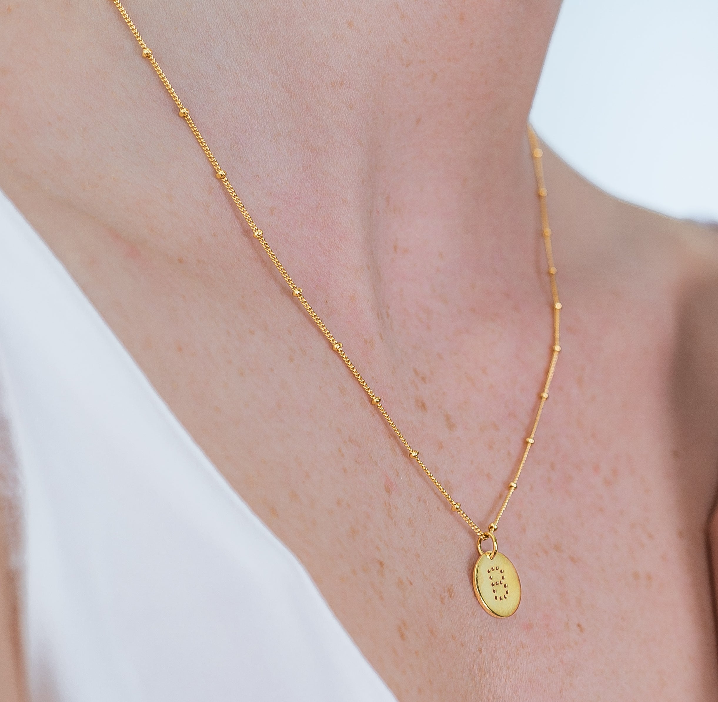 alphabet necklace with letter pendant in 18ct Gold Vermeil on model