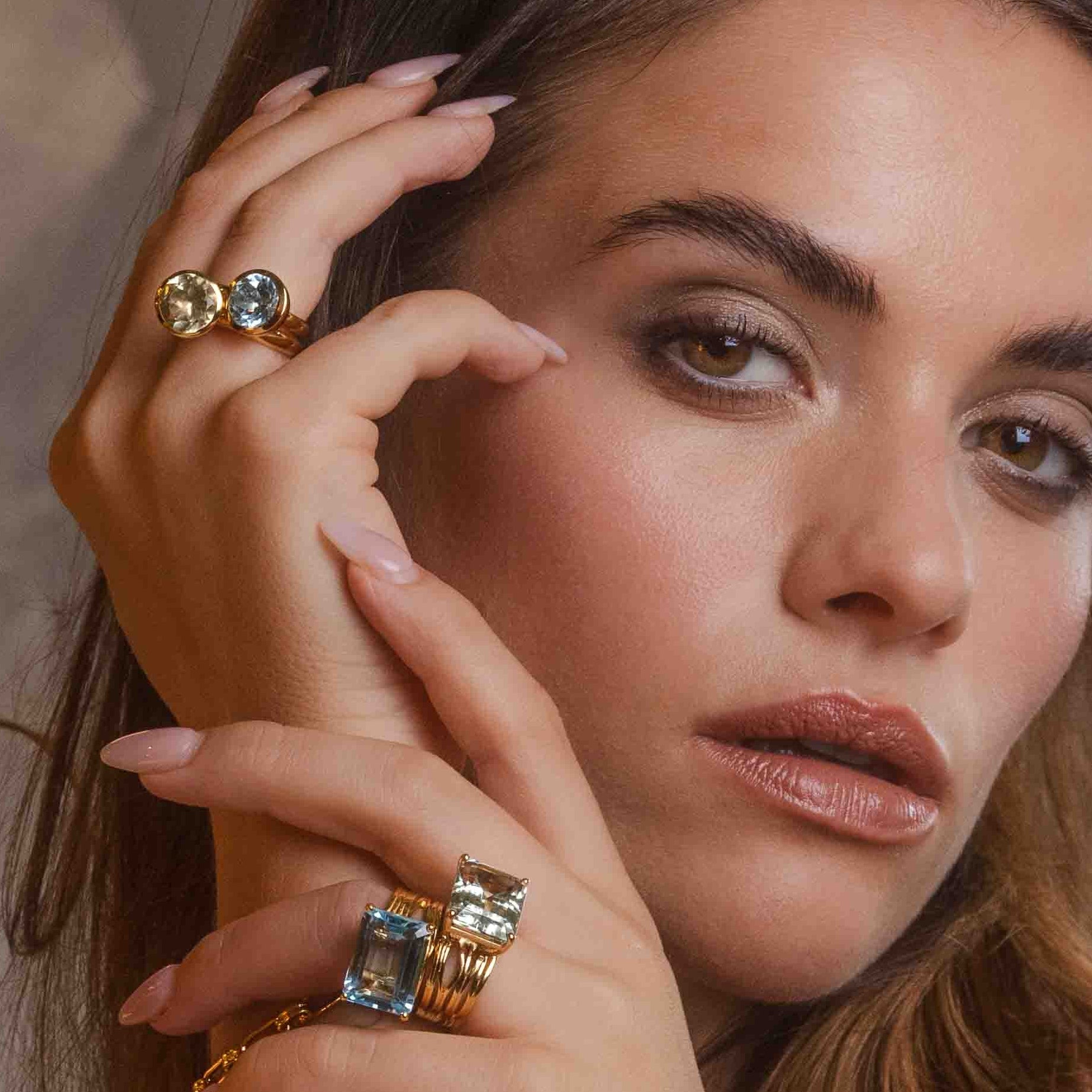 Gold jewellery with colourful gemstones on model